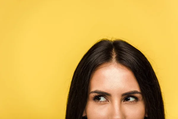 Cropped view of young dreamy woman isolated on orange — Stock Photo