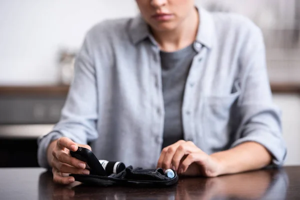 Selective focus of woman touching first aid kit — Stock Photo