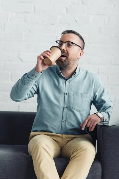 Bell'uomo d'affari in bicchieri bere caffè dalla tazza usa e getta — Foto stock