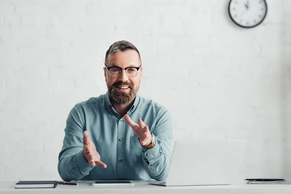 Handsome businessman in shirt showing gesture and looking at camera — Stock Photo