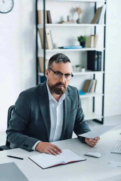 Handsome businessman in formal wear and glasses doing paperwork — Stock Photo