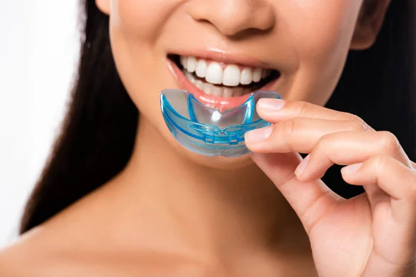 Cropped view of woman using mouth guard isolated on white — Stock Photo