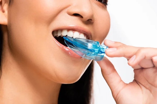 Cropped view of asian woman using mouth guard isolated on white — Stock Photo