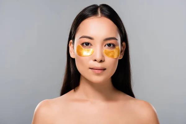 Naked asian woman with eye patches on face isolated on grey — Stock Photo