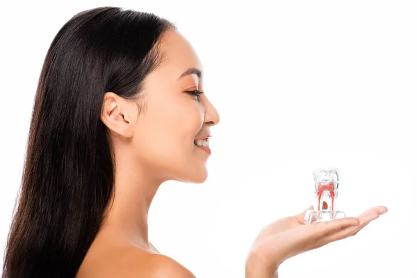 Side view of happy naked asian woman holding tooth model isolated on white — Stock Photo