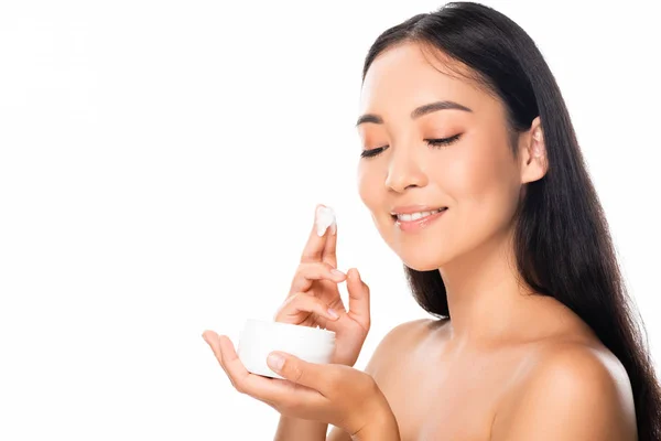 Naked beautiful asian woman applying cosmetic cream isolated on white — Stock Photo