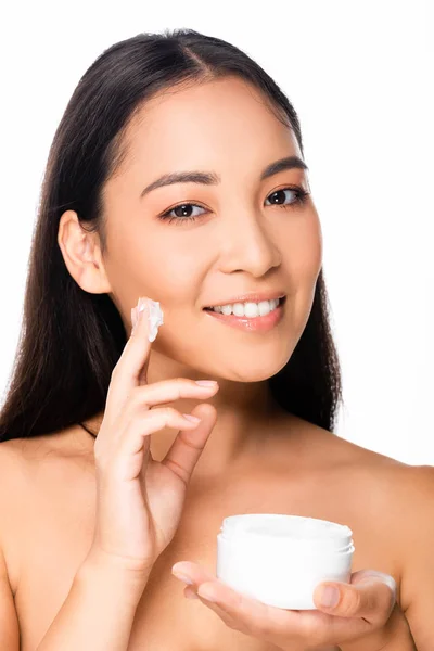 Naked beautiful asian woman with cosmetic cream on fingers isolated on white — Stock Photo