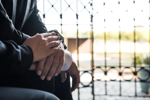 Cropped view of senior man and woman touching hands — Stock Photo