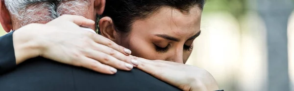 Panoramic shot of woman hugging senior man — Stock Photo