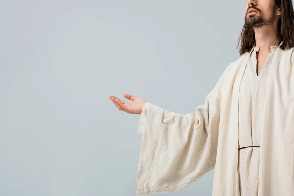 Обрізаний вид Ісуса з витягнутою рукою ізольовано на сірому — стокове фото