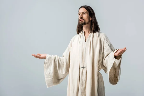 Religiöser Mann mit ausgestreckten Händen steht isoliert auf grau — Stockfoto