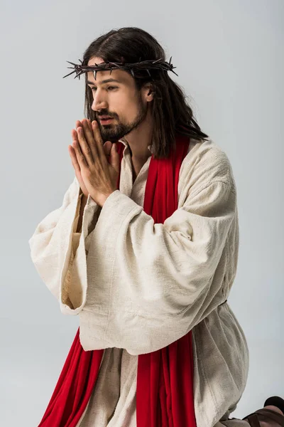Religious man with praying hands and jesus robe isolated on grey — Stock Photo