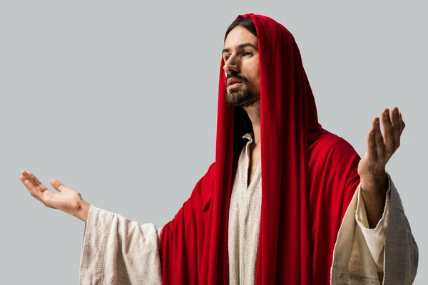 Handsome bearded man in red hood with outstretched hands isolated on grey — Stock Photo