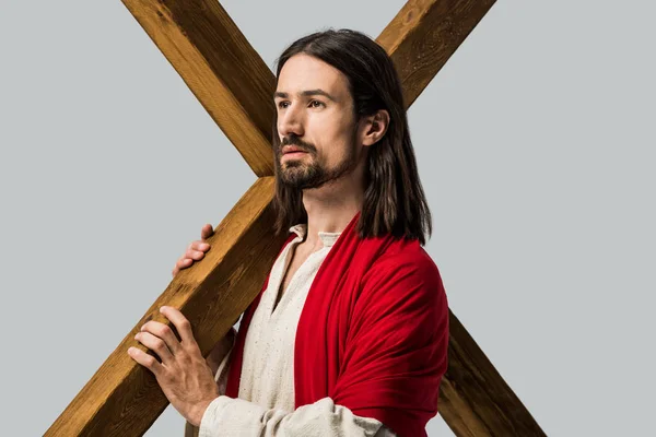 Jesus holding wooden cross isolated on grey — Stock Photo