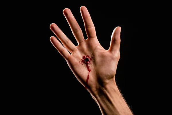 Cropped view of religious man with bloody hand isolated on black — Stock Photo