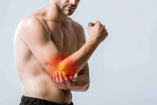 Partial view of sportsman with elbow pain isolated on grey — Stock Photo