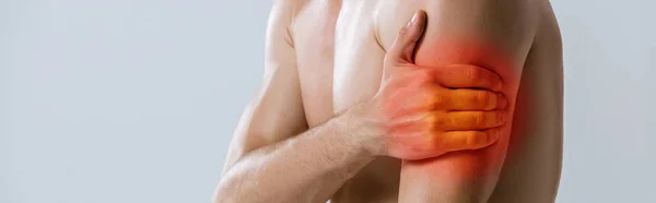 Panoramic shot of shirtless sportsman with arm pain isolated on grey — Stock Photo