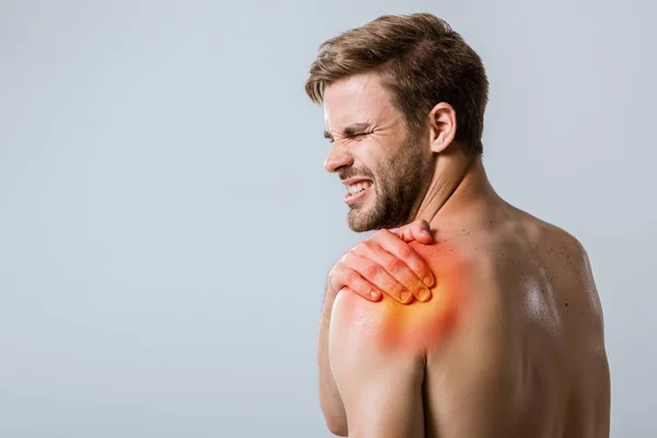 Shirtless bearded sportsman with shoulder pain isolated on grey — Stock Photo