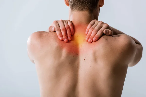 Cropped view of shirtless man with neck pain isolated on grey — Stock Photo