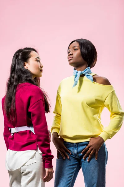 Attractive asian and african american friends  looking away isolated on pink — Stock Photo
