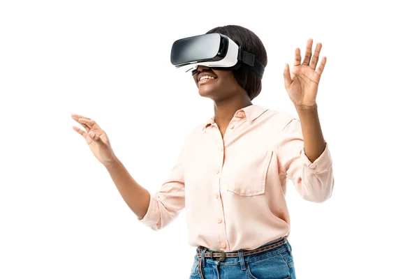 Smiling african american woman in shirt with virtual reality headset isolated on white — Stock Photo