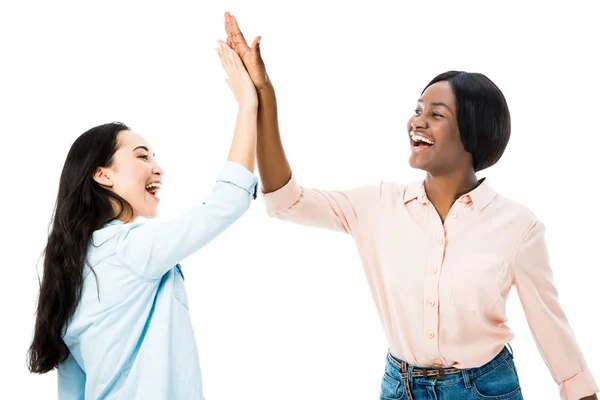 Smiling asian and african american friends giving high five isolated on white — Stock Photo