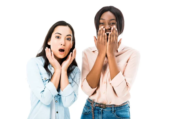 Shocked asian and african american friends looking at camera isolated on white — Stock Photo