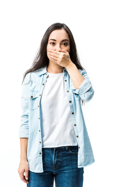 Attractive and shocked asian woman in denim shirt obscuring face isolated on white — Stock Photo