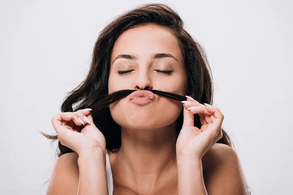 Brunette beautiful woman with closed eyes making fake mustache from long healthy hair isolated on grey — Stock Photo