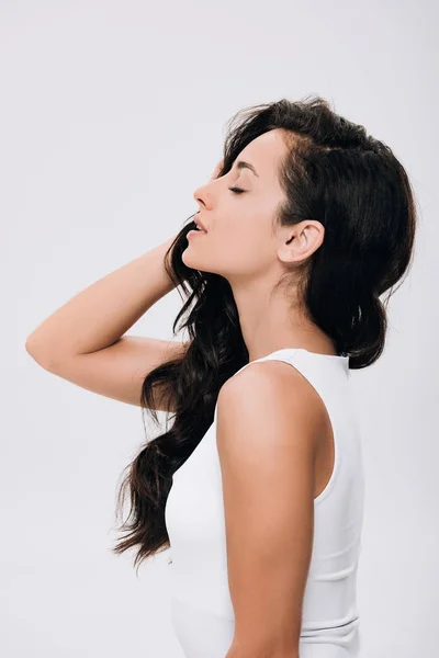 Side view of brunette beautiful woman with closed eyes and long healthy hair isolated on grey — Stock Photo
