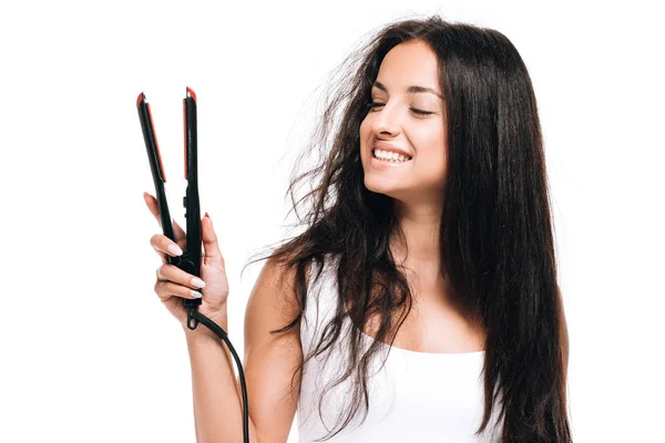 Happy brunette beautiful woman with straight and curly hair holding flat iron  isolated on white — Stock Photo