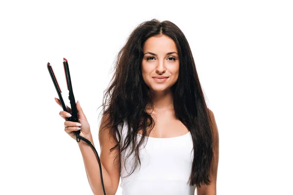 Smiling brunette beautiful woman with straight and curly hair holding flat iron  isolated on white — Stock Photo