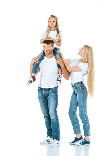 Happy father holding on shoulders cute daughter near wife on white — Stock Photo