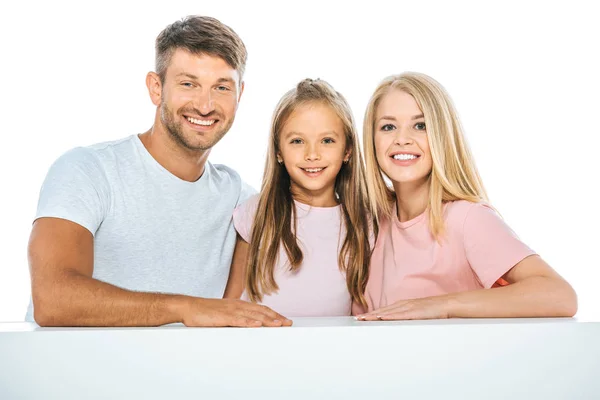 Daughter smiling near parents and looking at camera isolated on white — Stock Photo