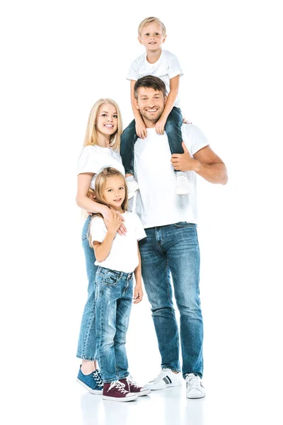 Happy father holding son on shoulders near wife and daughter on white — Stock Photo