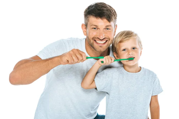 Cheerful man and son brushing teeth isolated on white — Stock Photo