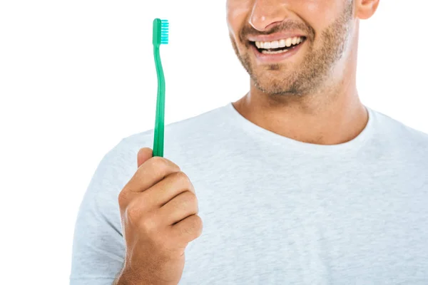 Cropped view of man holding toothbrush and smiling isolated on white — Stock Photo