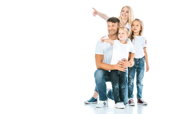 Positive Familie in Jeans, die mit Fingern auf Weiß zeigt — Stockfoto