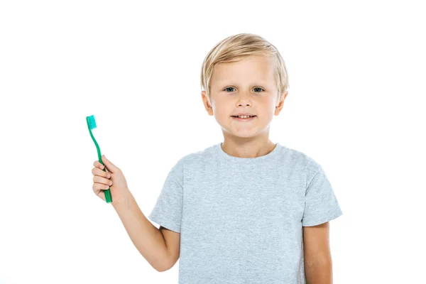 Mignon et heureux enfant tenant brosse à dents isolé sur blanc — Photo de stock