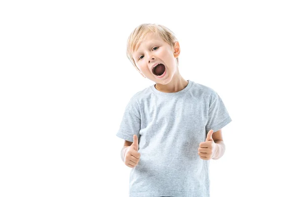 Excited boy with opened mouth showing thumbs up isolated on white — Stock Photo