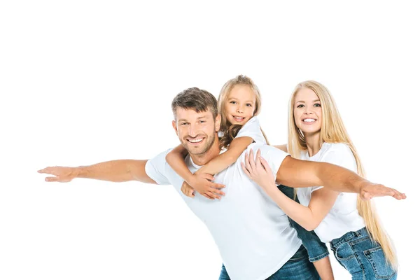 Счастливый отец с протянутыми руками рядом с дочерью и привлекательной женой, изолированной на белом — стоковое фото