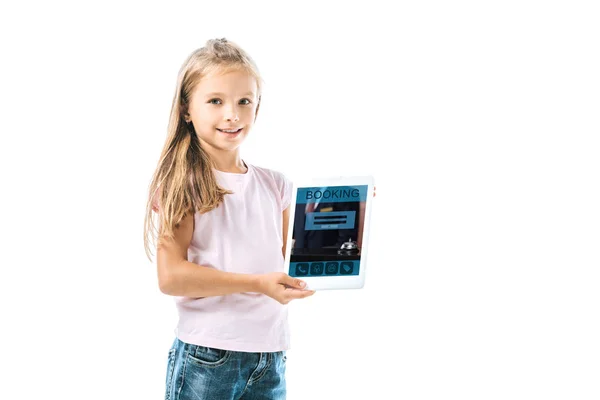 Cheerful kid holding digital tablet with booking app on screen isolated on white — Stock Photo