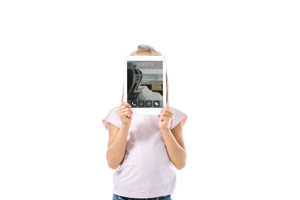 Kid covering face while holding digital tablet with tickets app on screen isolated on white — Stock Photo