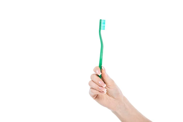 Abgeschnittene Ansicht einer Frau mit grüner Zahnbürste isoliert auf weiß — Stockfoto