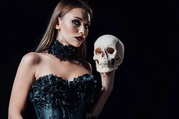 Effrayant vampire fille en noir gothique robe tenant crâne humain isolé sur noir — Photo de stock