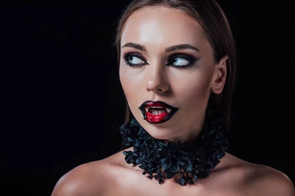 Naked scary vampire girl with fangs looking away isolated on black — Stock Photo