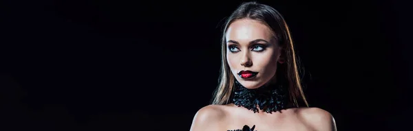 Panoramic shot of scary vampire girl in black gothic dress looking away isolated on black — Stock Photo