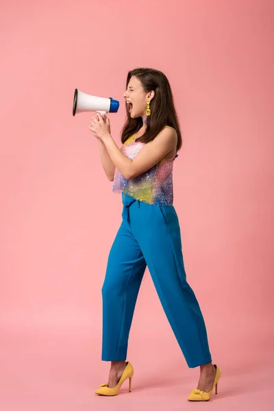 Pleine longueur vue de colère jeune fille disco élégant crier en mégaphone sur rose — Photo de stock