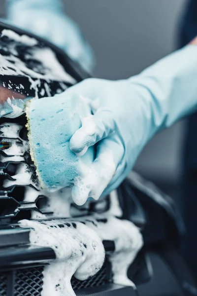 Partial view of car cleaner washing car with sponge and detergent — Stock Photo