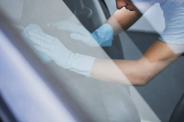 Selective focus of car cleaner wiping car seat with rag — Stock Photo